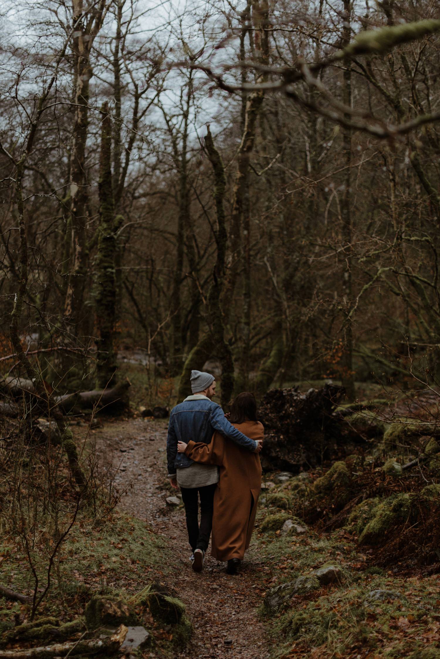 couple walking in scottish woods